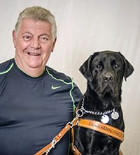 John DiMarco with a black lab.