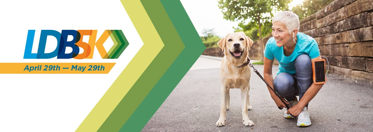 LDB5K logo next to an image of a woman in activewear tying her running shoe while kneeling next to a yellow lab whose leash she is holding
