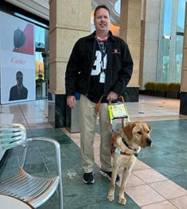 Joey and Tucker stand in front of a Cartier store in a mall.