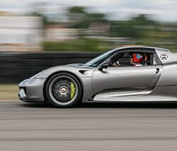 Gray sports car with blurred background as if going fast