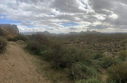 Arizona countryside with dirt/sand path along left side of photo