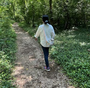 Woman walking on wooded trail