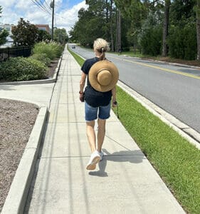 Celia walking with white cane