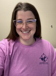Selfie of Lauren Wetzel in a pink shirt wearing glasses.