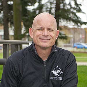 Stephen Moran in black polo with Leader Dog logo in white